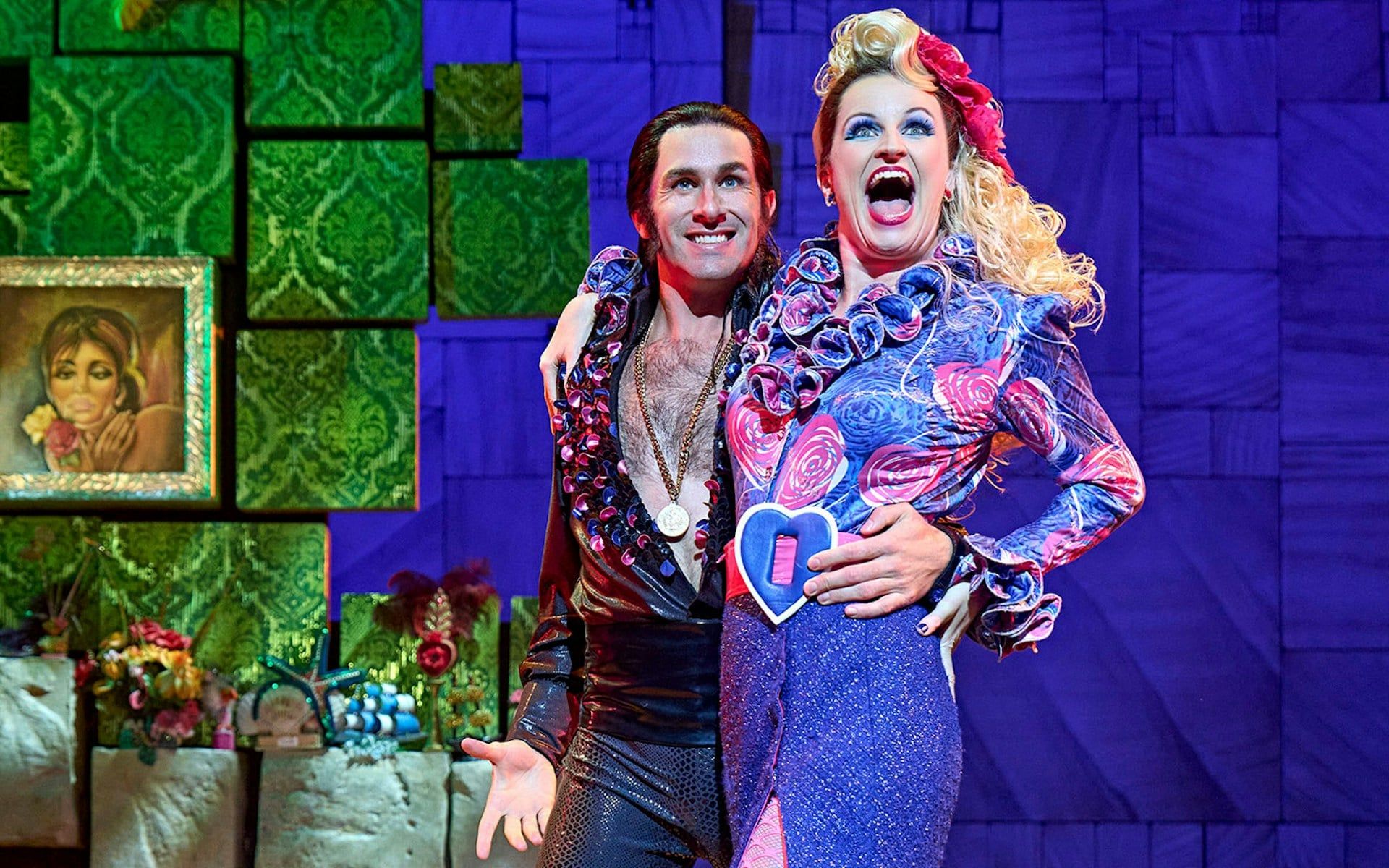 Performers in colorful costumes on stage during Matilda The Musical
