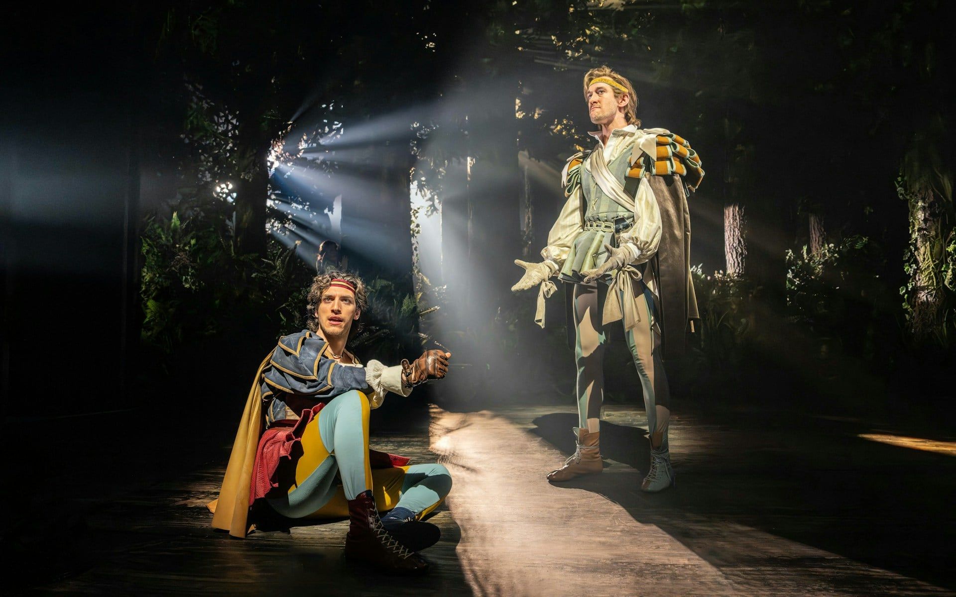 Actors performing in a forest scene from "Into The Woods" production