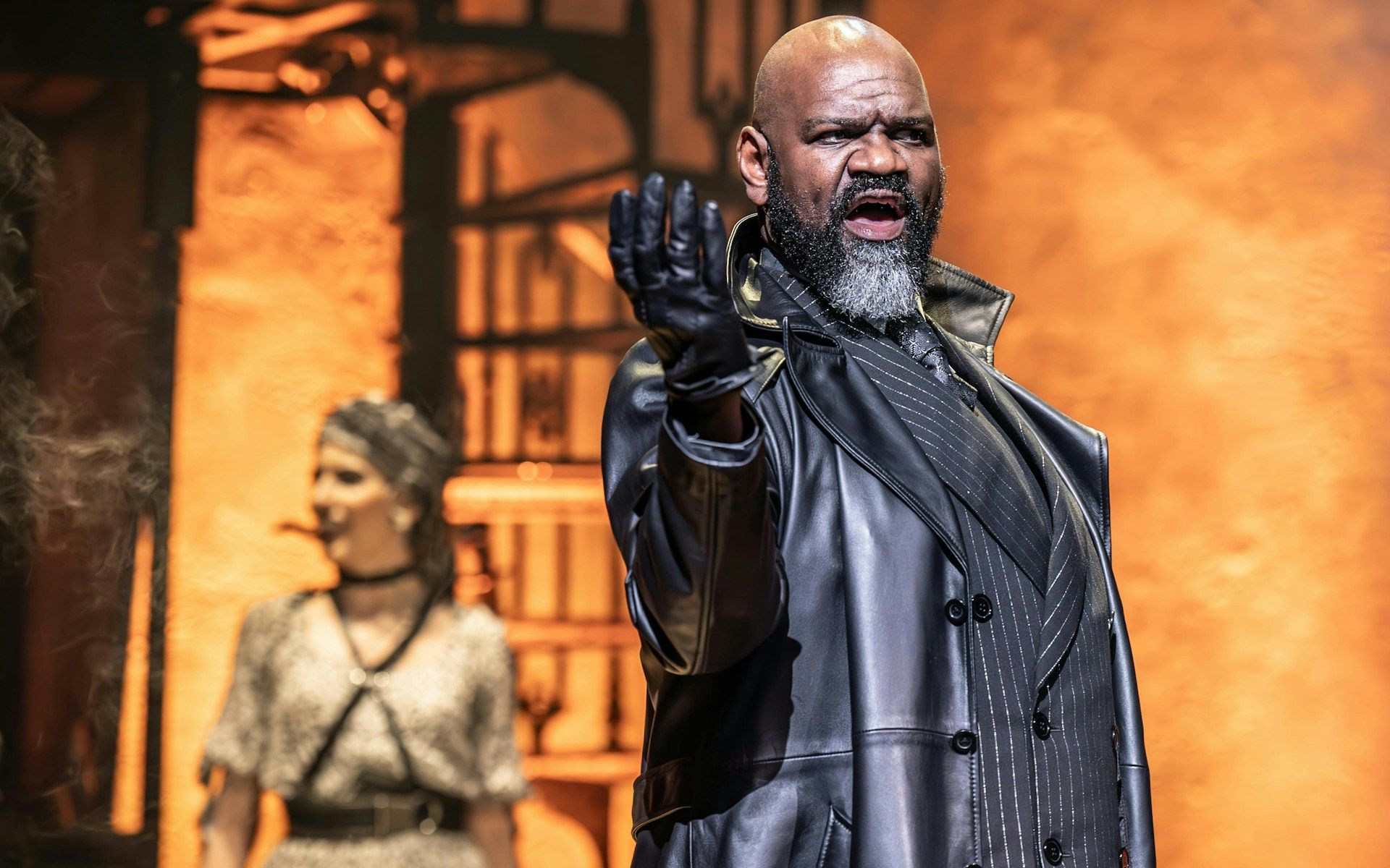 Stage performance of Hadestown in West End with actor in dramatic pose