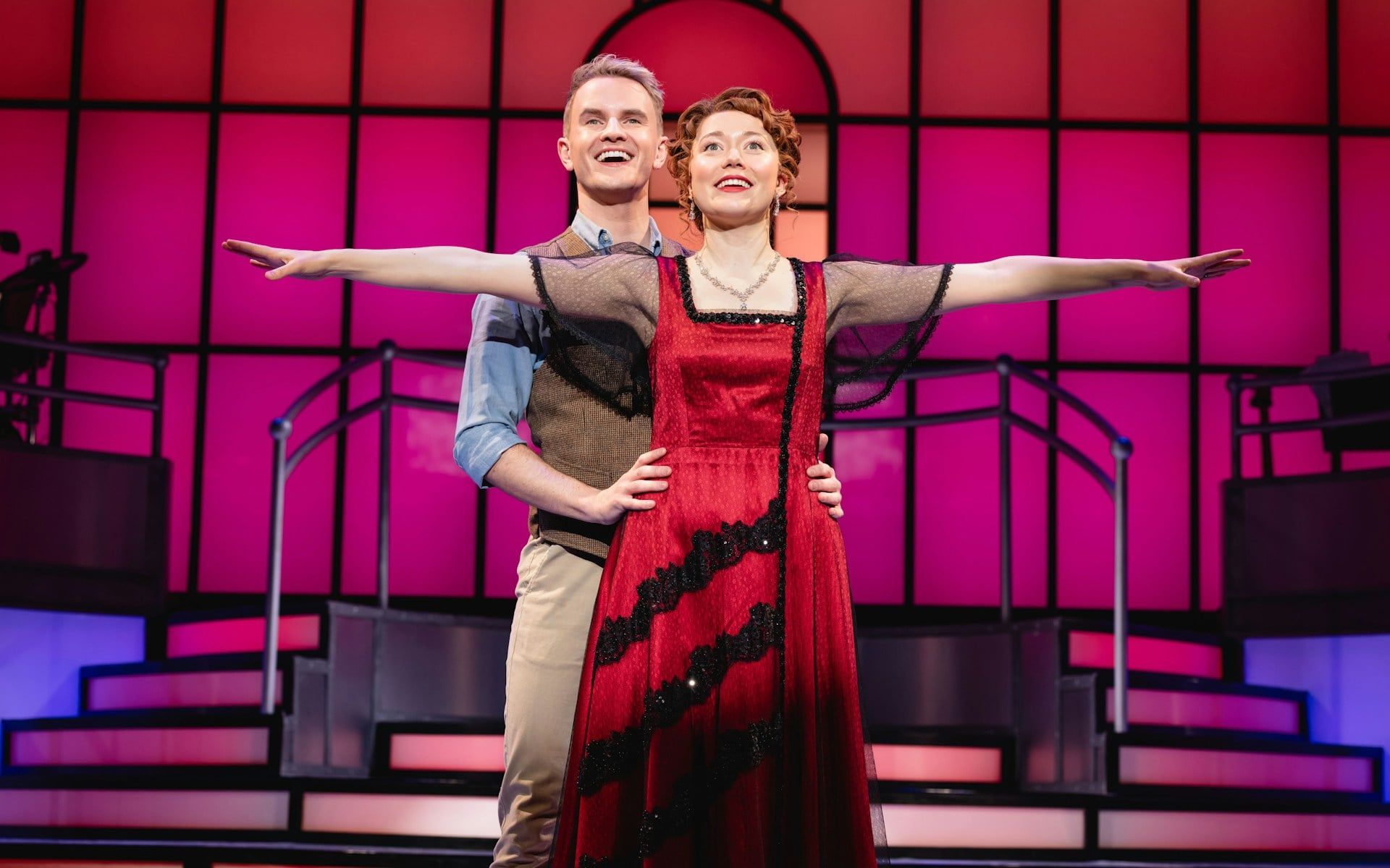Stage performance of Titanique Westend with actors in embrace on a vibrant set