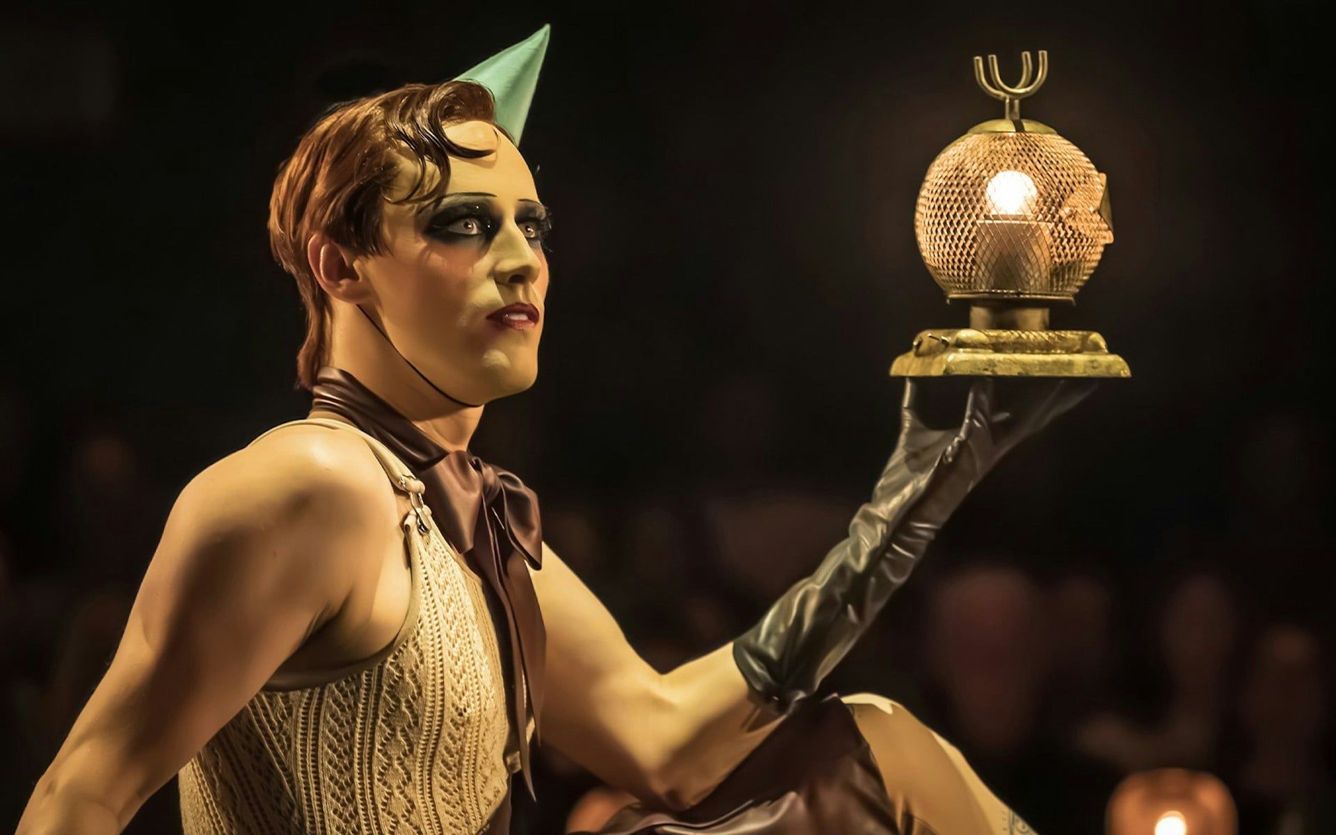 Performer holding a lit prop during Cabaret Westend show
