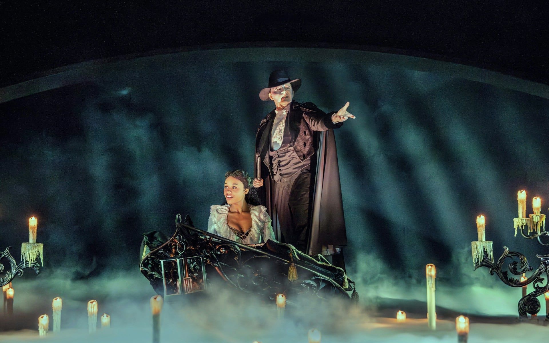 Phantom of the Opera scene with characters on a boat surrounded by candles and mist — The Phantom of the Opera