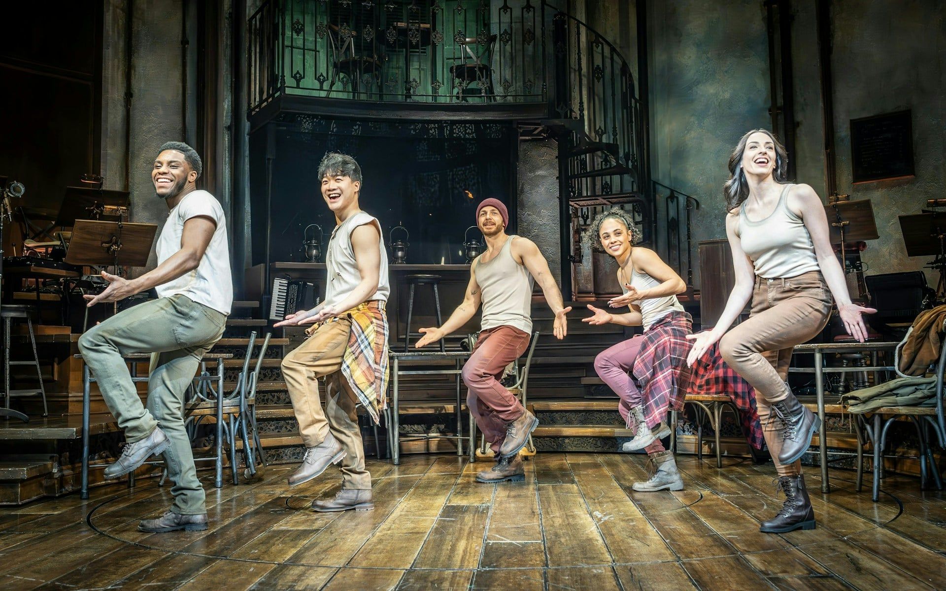 Performers dancing on stage during Hadestown show in West End theater