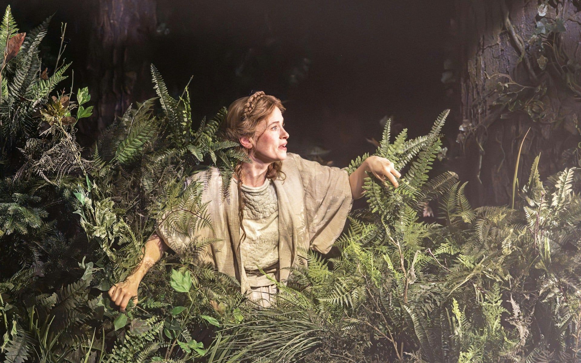 Performer in forest setting during "Into The Woods" production