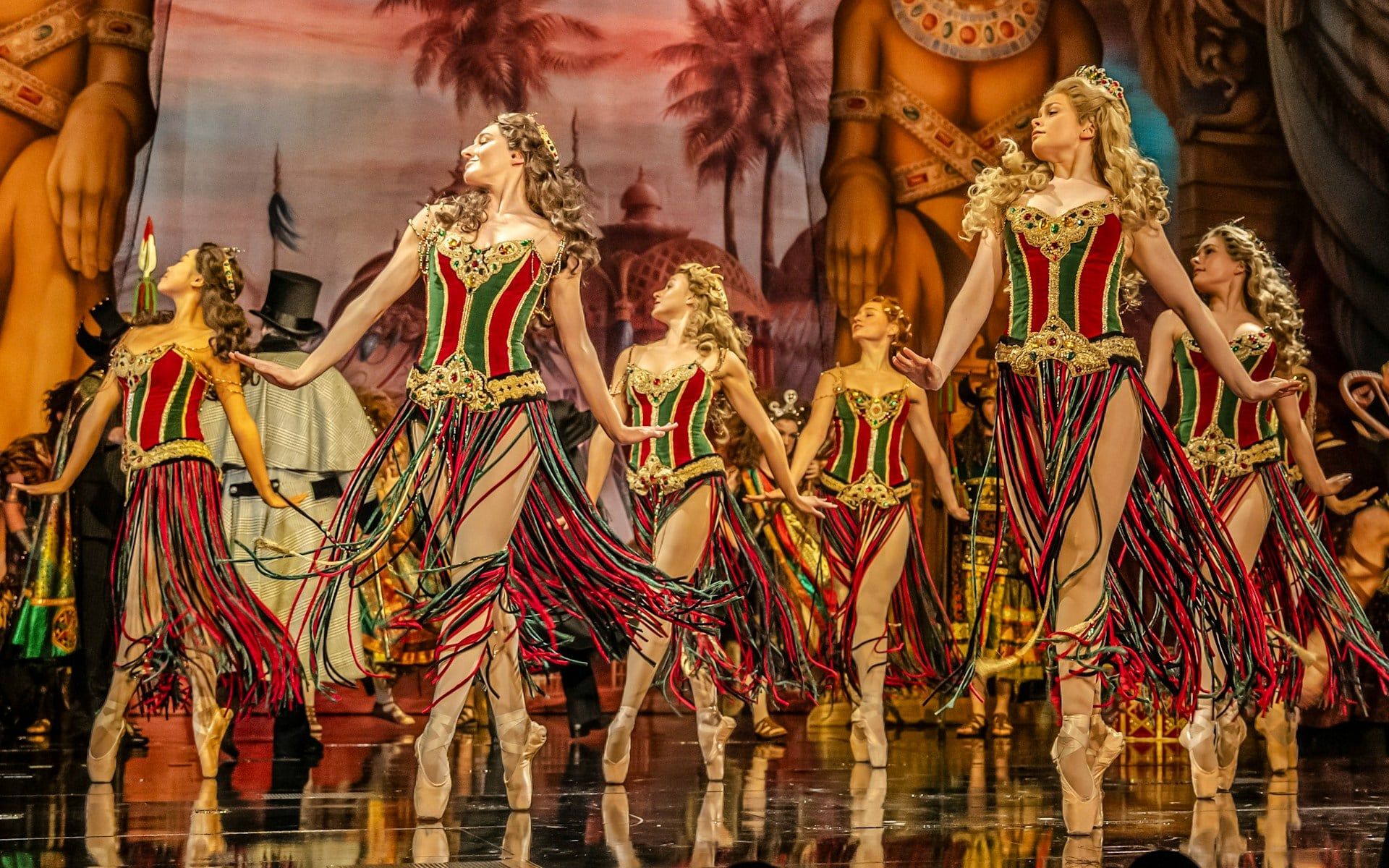 Dancers in colorful costumes perform on stage during Phantom of the Opera production — The Phantom of the Opera