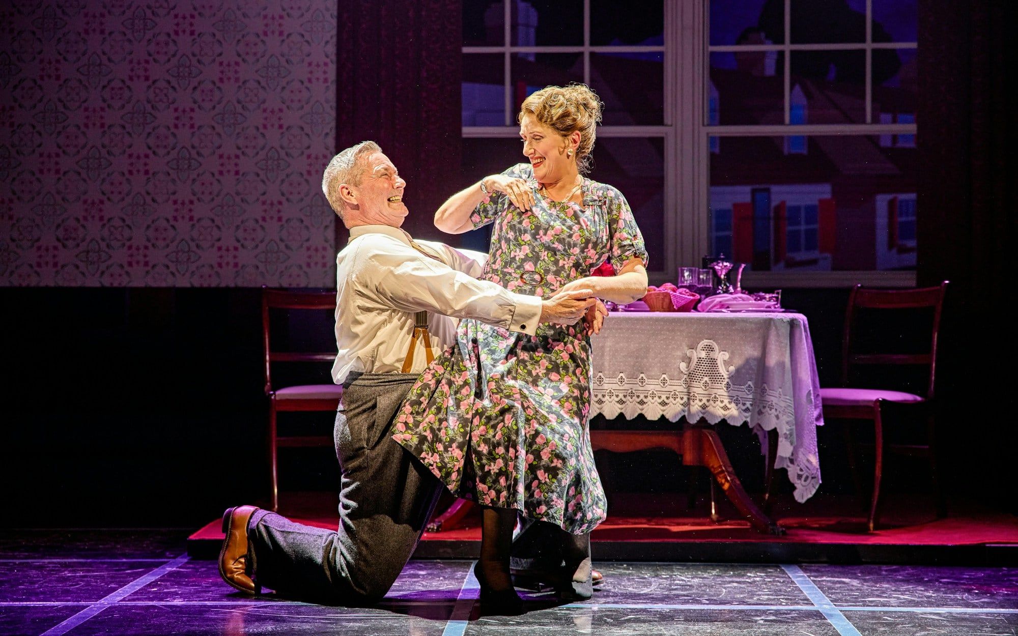 Couple dancing in a scene from Sinatra The Musical, Westend, with a dining table in the background