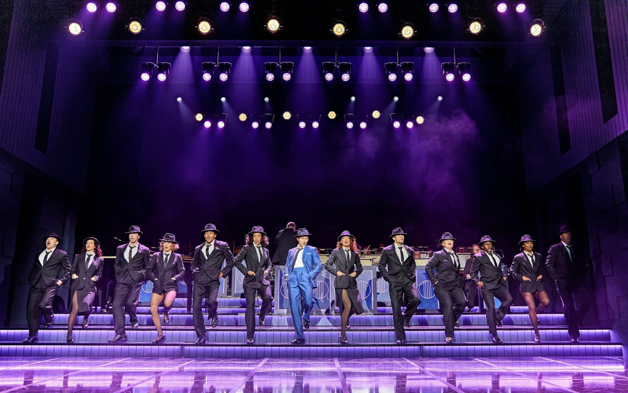 Performers in suits and hats dancing on stage in Sinatra The Musical, West End
