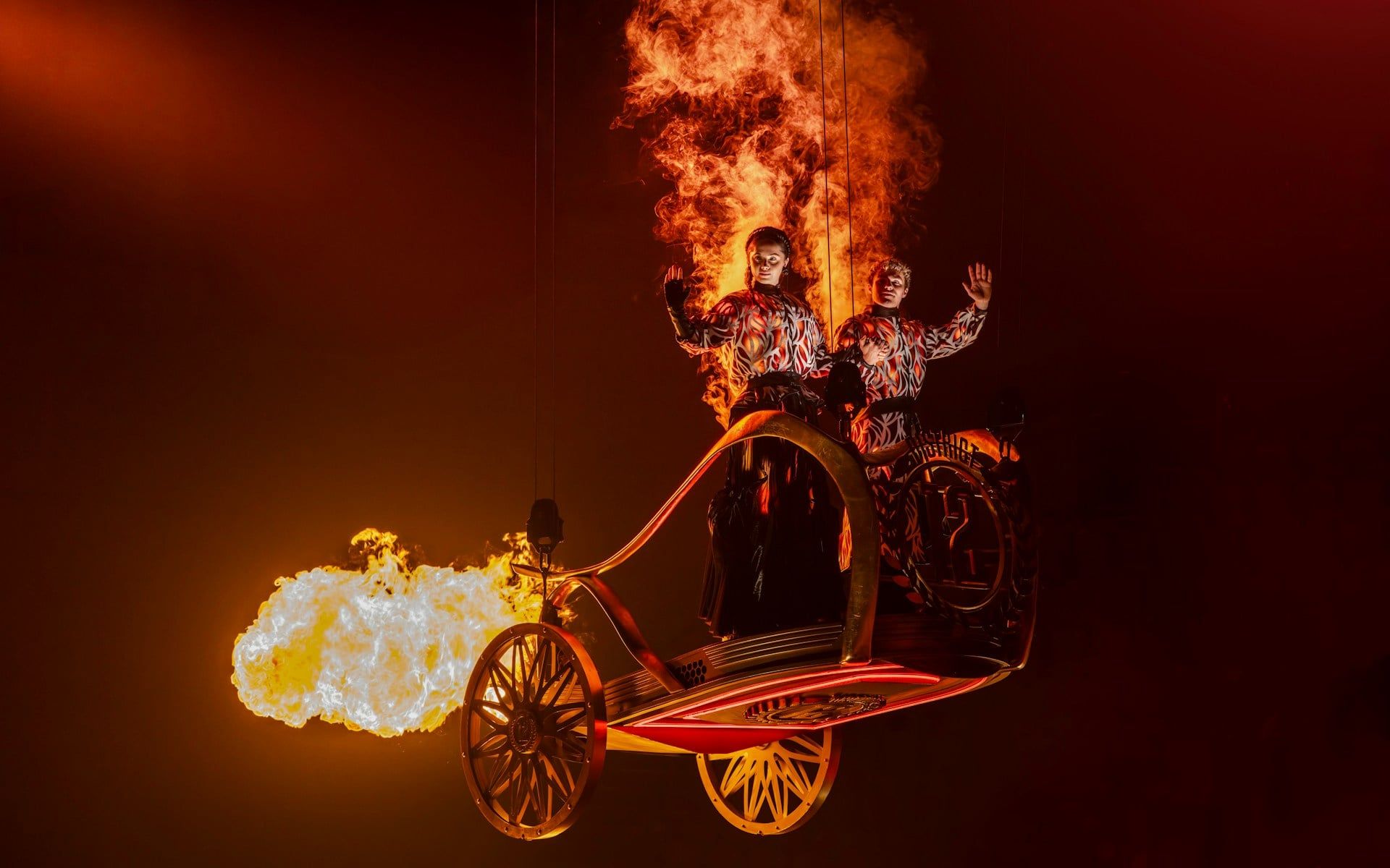 Performers in fiery costumes on stage during Hunger Games West End show — The Hunger Games