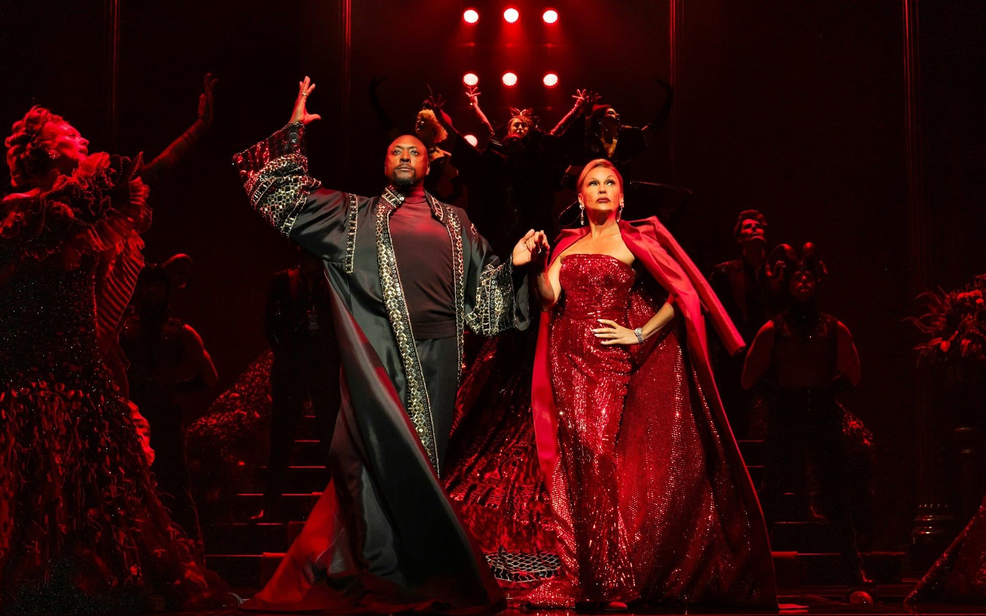 Stage performance of The Devil Wears Prada West End show with actors in elaborate costumes