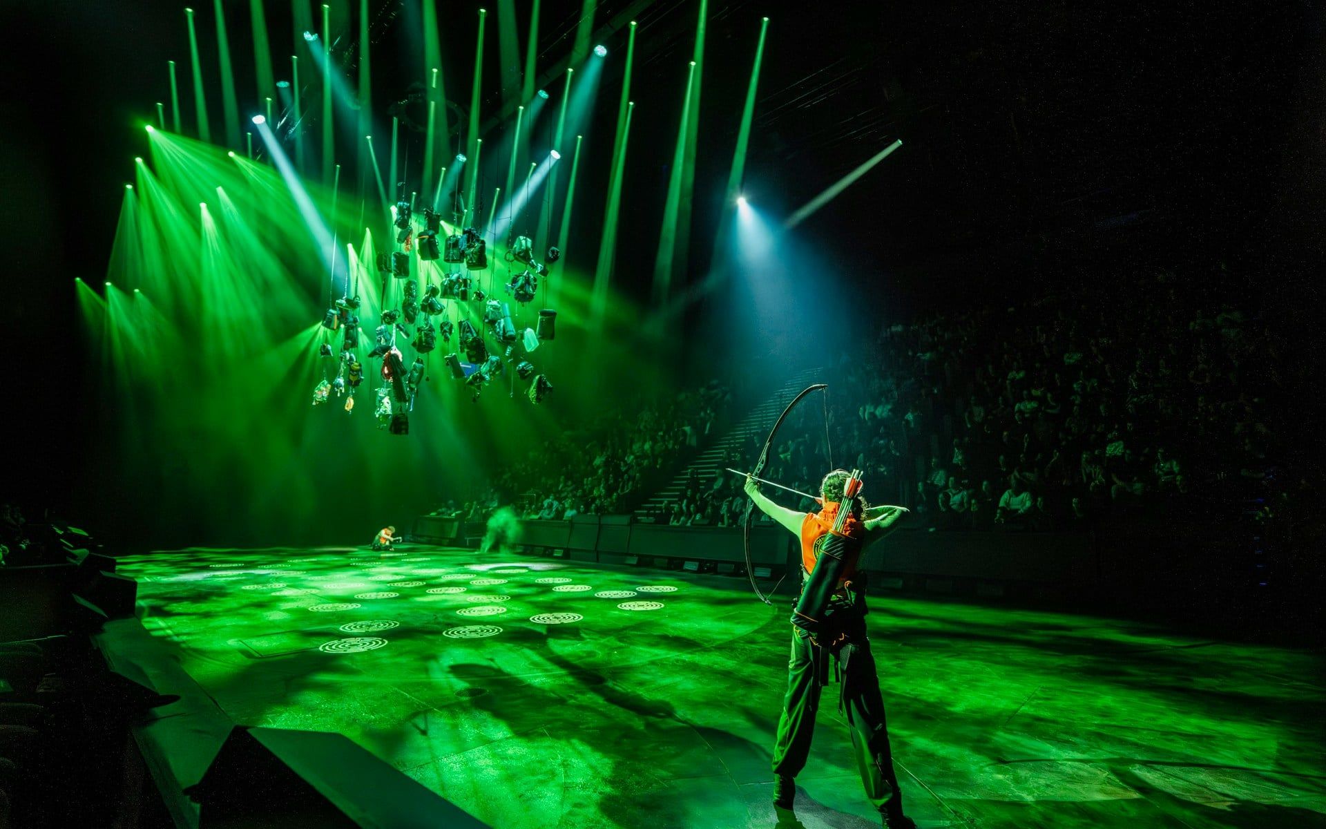 Performer with bow on stage during Hunger Games West End show — The Hunger Games