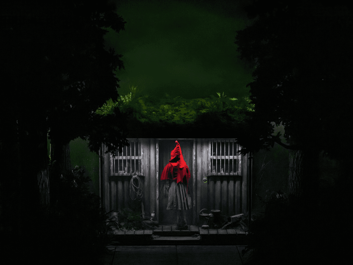 Person in red cloak standing at a cabin door in a dark forest setting — Into the Woods