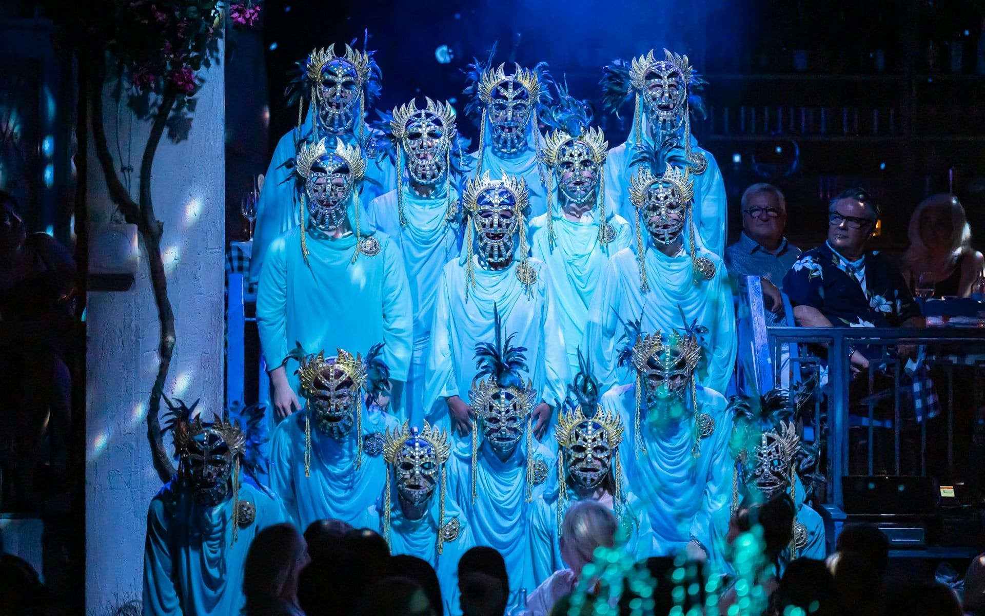 Performers in ornate masks during Mamma Mia! The Party show