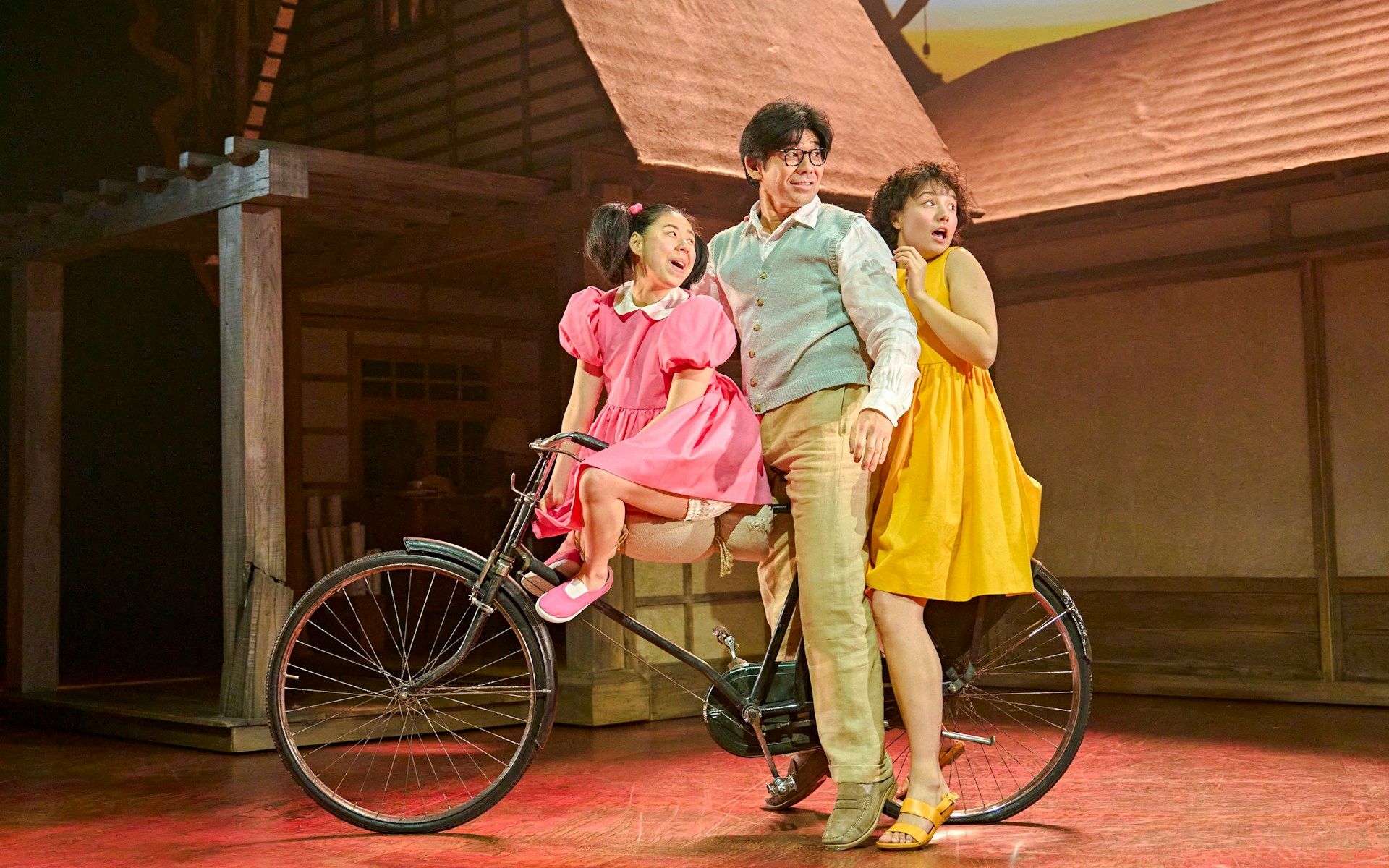 Stage actors on a bicycle in a scene from My Neighbour Totoro production