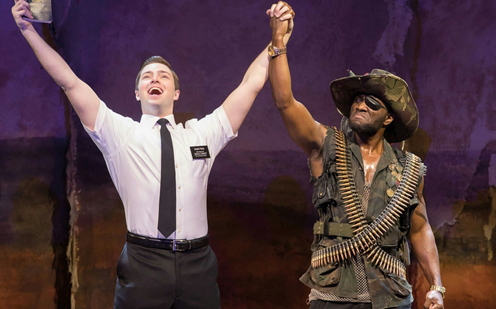 Actors performing in "The Book of Mormon" musical scene
