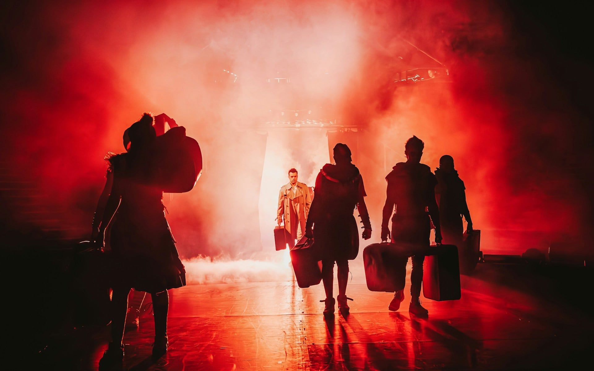 Performers on stage in dramatic lighting during Come Alive Westend show