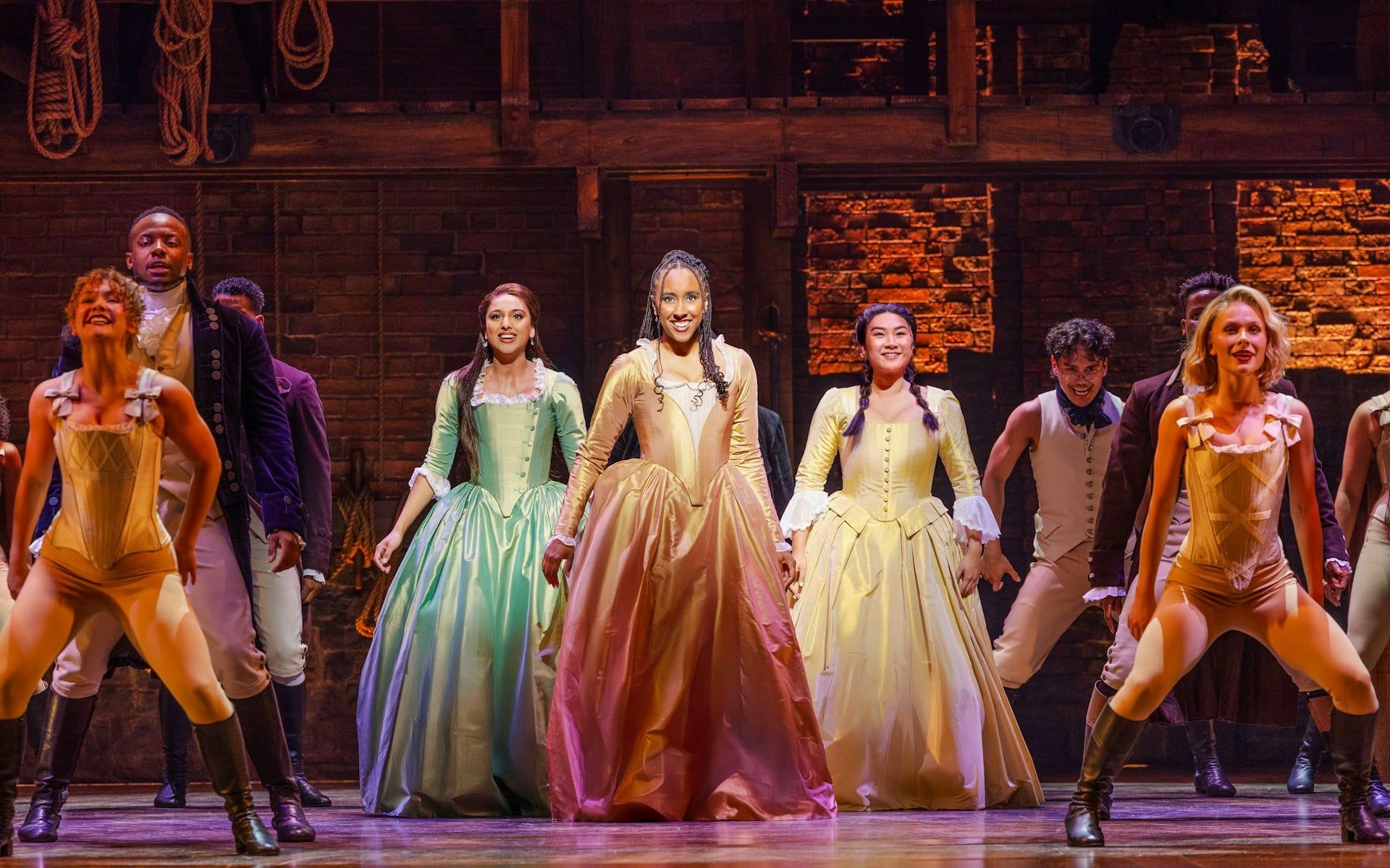 Cast performing on stage in a scene from the musical Hamilton