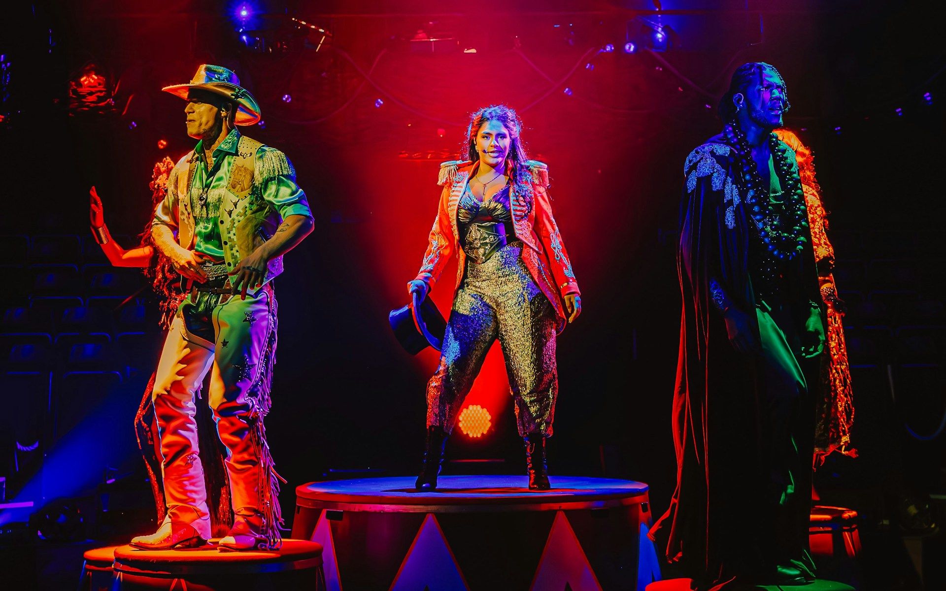 Performers on stage during Come Alive Westend show, featuring vibrant costumes and dramatic lighting