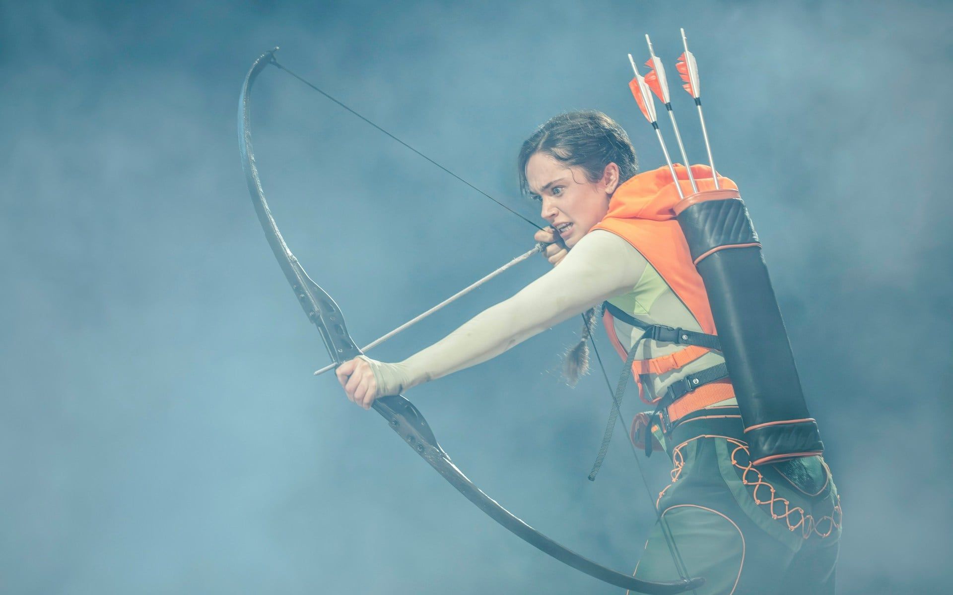 Performer with bow and arrows in Hunger Games West End show — The Hunger Games