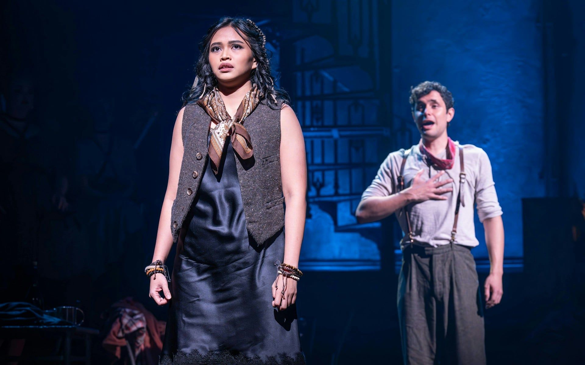 Actors performing a scene from Hadestown on West End stage