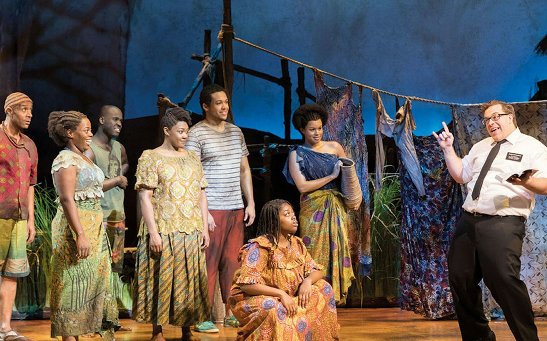 Cast performing a scene from The Book of Mormon in London theater