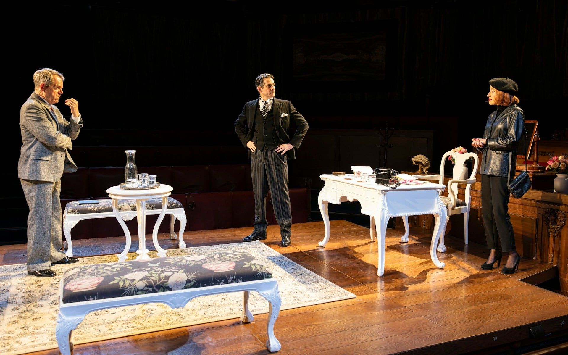 Courtroom scene from "Witness for the Prosecution" play with three actors on stage