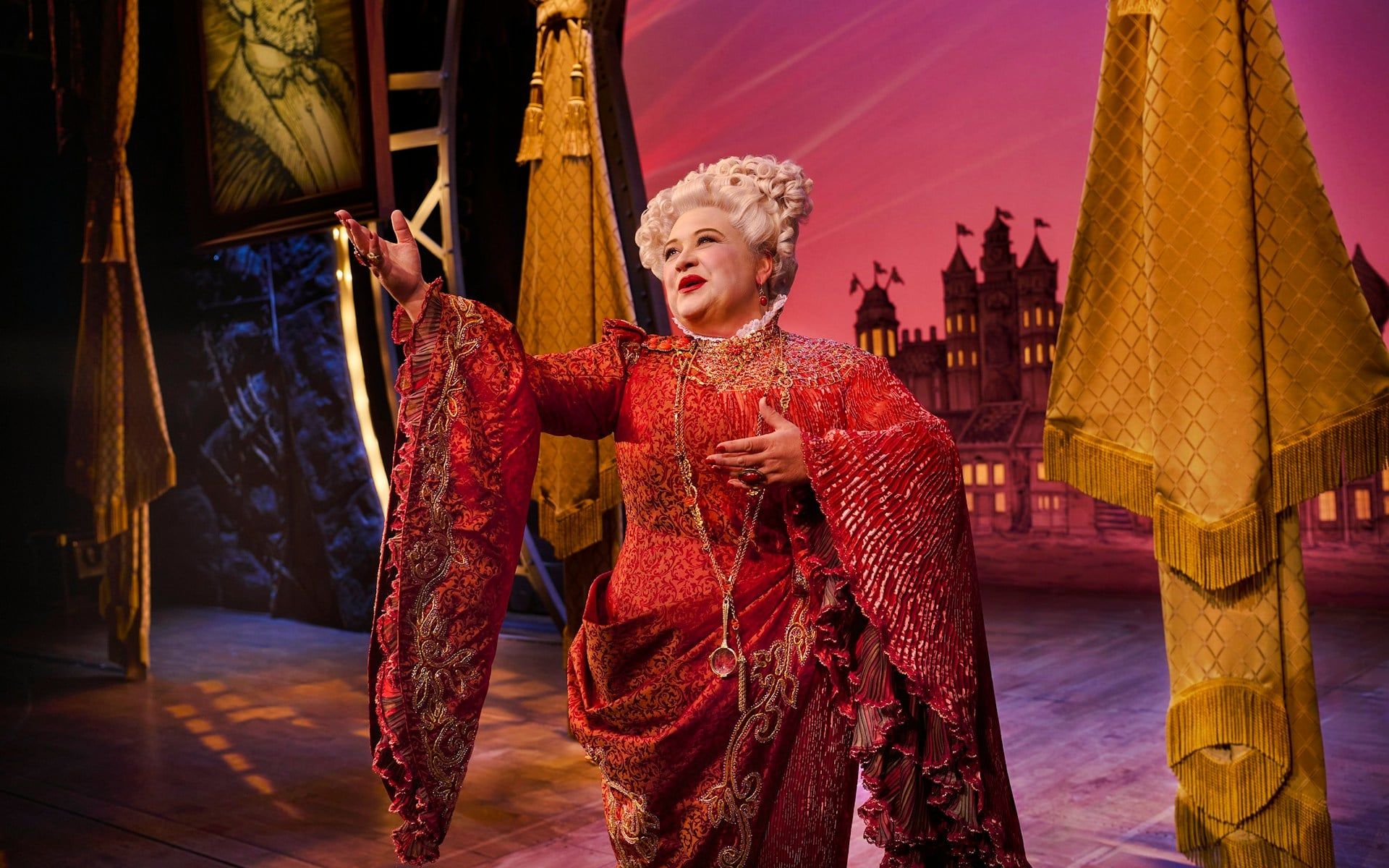 Performer in ornate costume on stage during Wicked musical