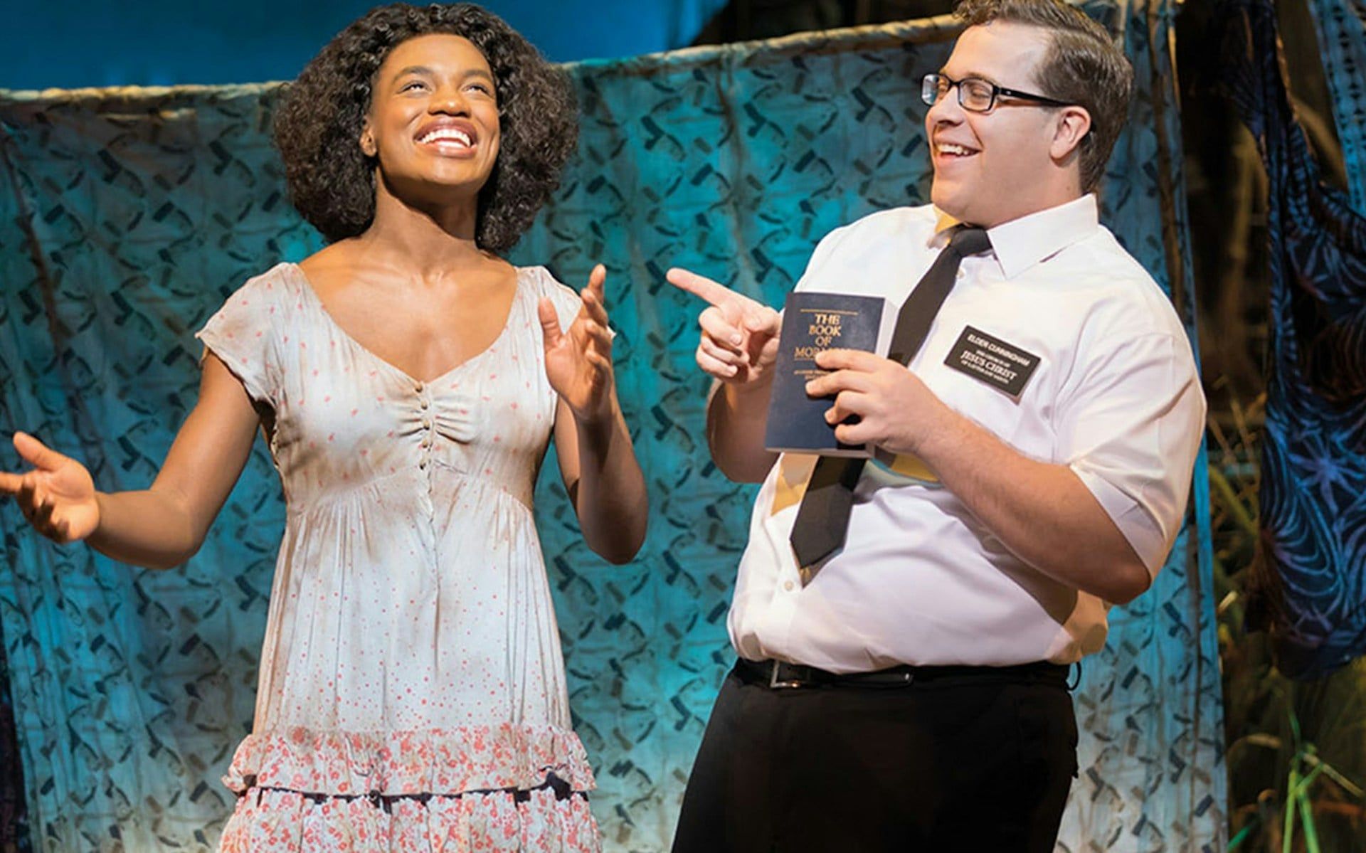 Actors performing a scene from The Book of Mormon musical