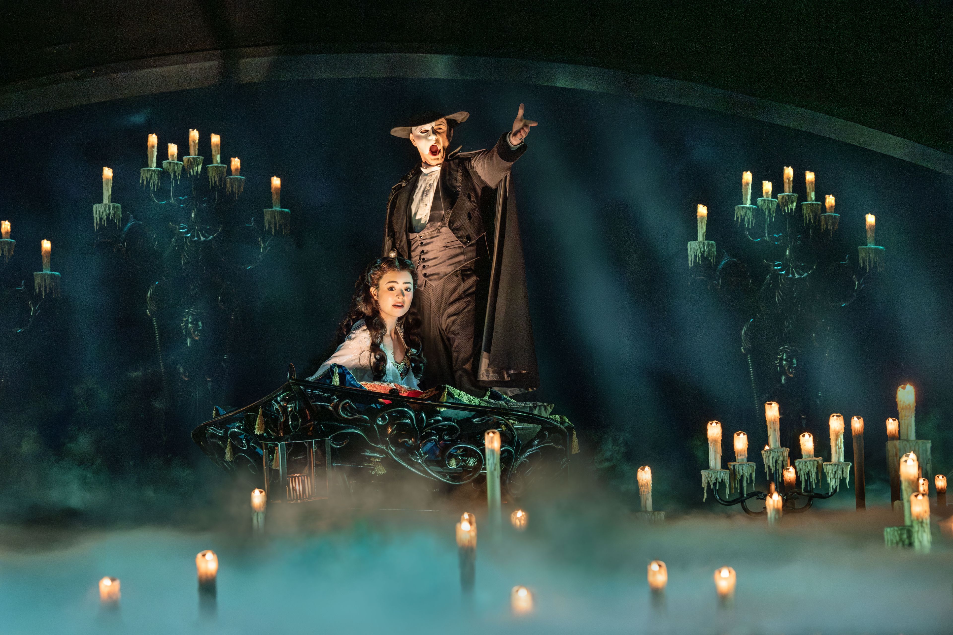 The Phantom leads Christine by candlelight to his lair, The Phantom of the Opera. Photo by Johan Persson