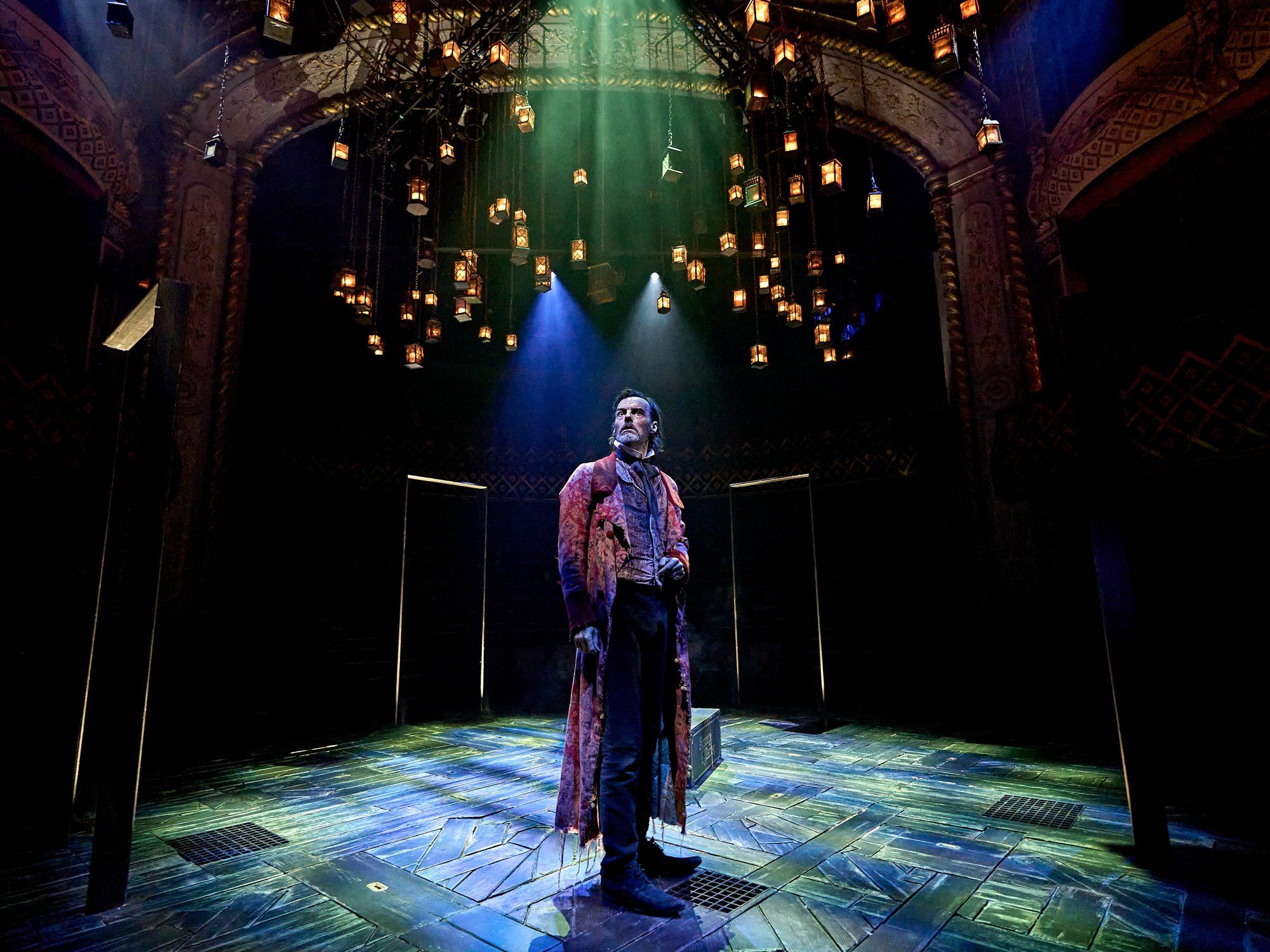 A Christmas Carol at The Old Vic (previous year's production): Scrooge alone on the in-the-round stage beneath hundreds of hanging lanterns. Photo: Manuel Harlan