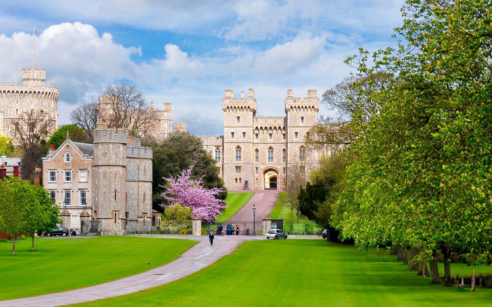Windsor Castle exterior with lush gardens and pathway, England.