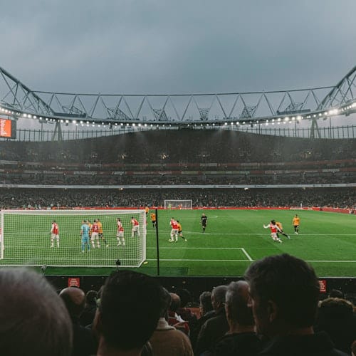 Audience watching Arsenal play from behind the goal