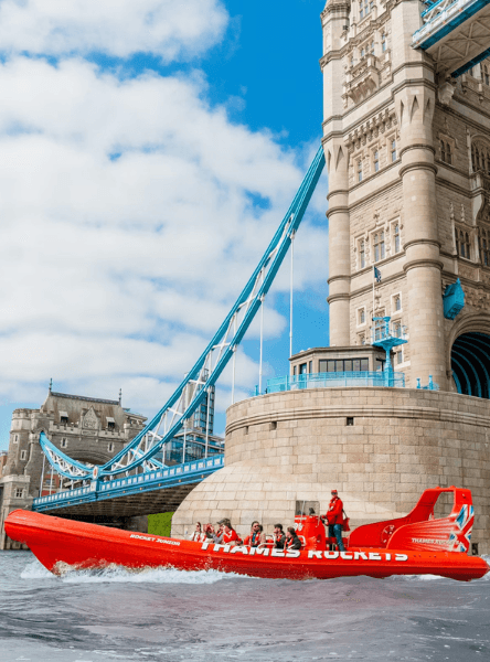Thames Rockets Speedboat Experience: The sleek red Thames Rocket RIB speeds under Tower Bridge.