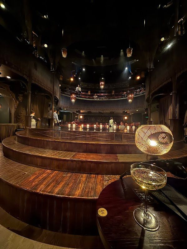 Cabaret audience view showing the theatrical staging and lighting