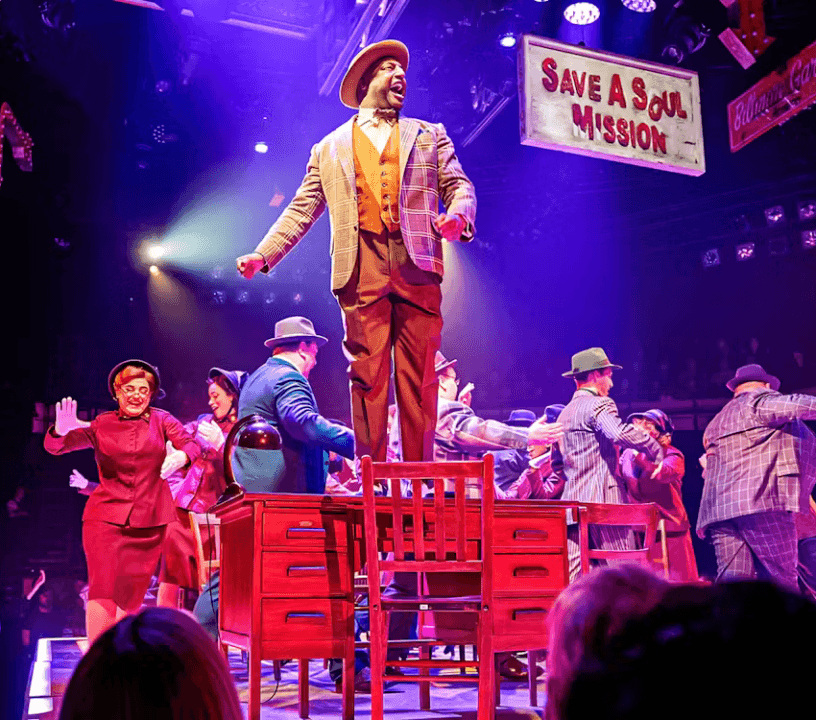 Guys and Dolls ensemble cast performing a showstopping musical number