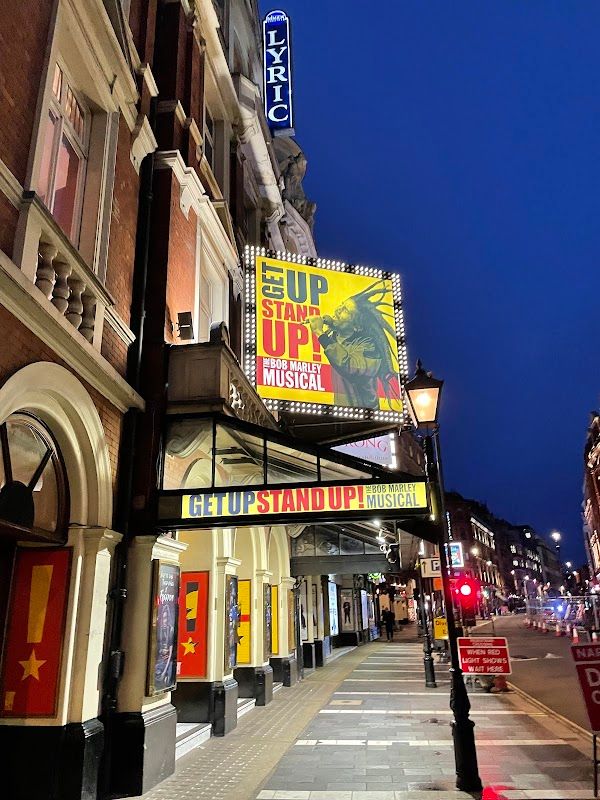 Hadestown audience view showing the theatrical staging and lighting