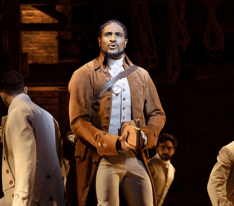 Hamilton ensemble cast performing a showstopping musical number