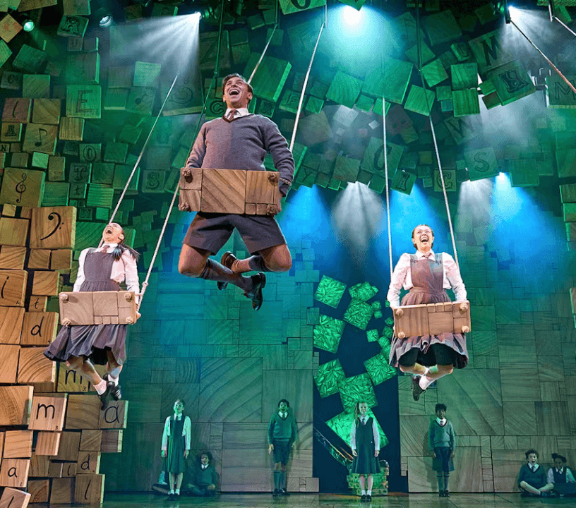 Matilda The Musical ensemble cast performing a showstopping musical number