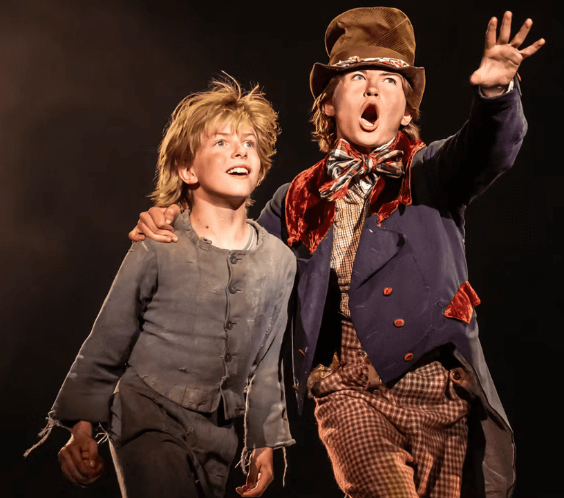 Oliver! ensemble cast performing a showstopping musical number