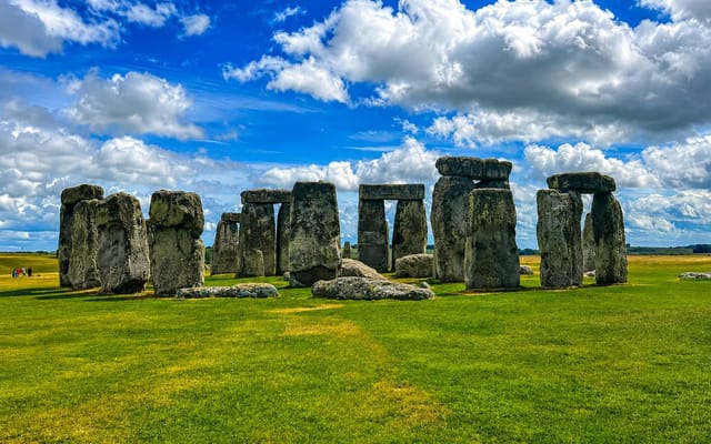 Small tour group at Stonehenge on a day trip from London taking in Castle Combe and Bath
